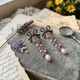 Lange oorbellen strik met amethist, parels en strass