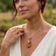 spessariet granaat kristal en spessariet granaat aan hangoog Starborn Creations