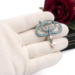 Broche slang zilver met turkoois en parels