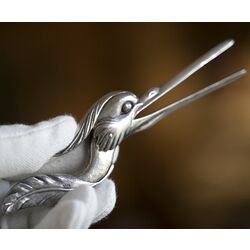 Zilveren luiertang in de vorm van een reigerkop