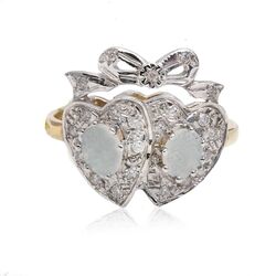Gouden ring met twee harten bezet met opaal en een strik met diamantjes